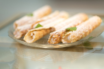 Tube dessert cake of puff pastry with cream. Delicious cream horns filled with vanilla cream.