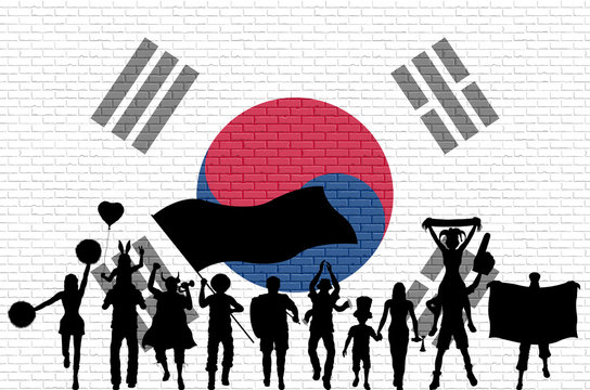 Korean supporter silhouette in front of brick wall with South Korea flag