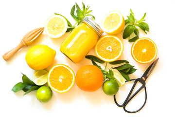 Set of citruses on white background, flat lay. Top view on oranges, lemons, lime and mint. Making detox freshes concept and recipe mockup. Top view. Tropical background.