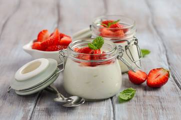 Homemade natural yogurt with strawberries and mint, selective focus.