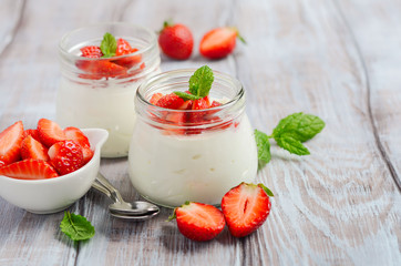 Homemade natural yogurt with strawberries and mint, selective focus.