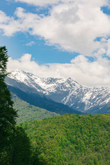 Fototapeta premium Amazing views in the Caucasus mountains. Snow-capped peaks, blue sky, sunny day