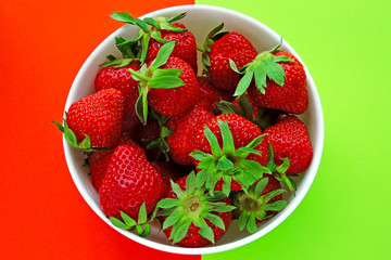 Fresh ripe strawberries in a bowl. Bright background.