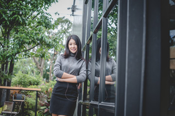 Portrait of designer woman standing in front of small vintage store. Small business