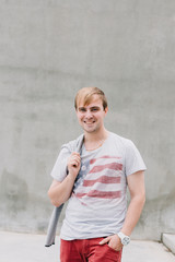 Portrait of a stylish man on a background of concrete structures.