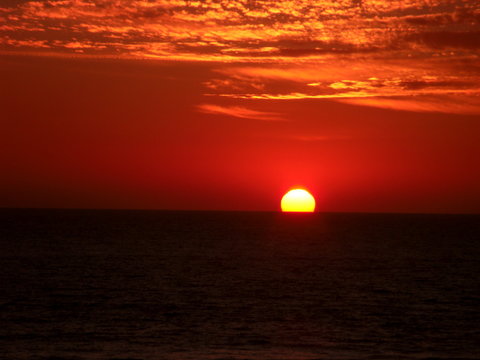 A fantastic, red sunset over the Tasmanian Sea seen from Manly Beach near Sydney, Australia.