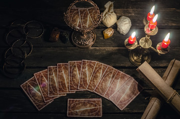 Tarot cards on fortune teller desk table background. Futune reading concept. Magic mirror on paranormal table.