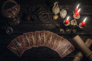 Tarot cards on fortune teller desk table background. Futune reading concept. Magic mirror and key to the fate.