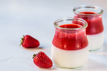 Light milk, dietary dessert with strawberries. Panna cotta. The concept of a healthy diet.