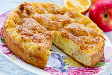 Juicy sponge cake with slices of orange and apple