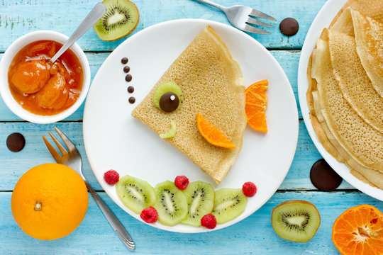 Fish pancakes with fruits and berries
