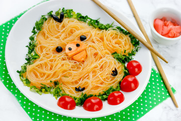 Fun food idea for kids - cute yellow chicken rice noodles funchoza with green onion and cherry tomatoes for healthy lunch
