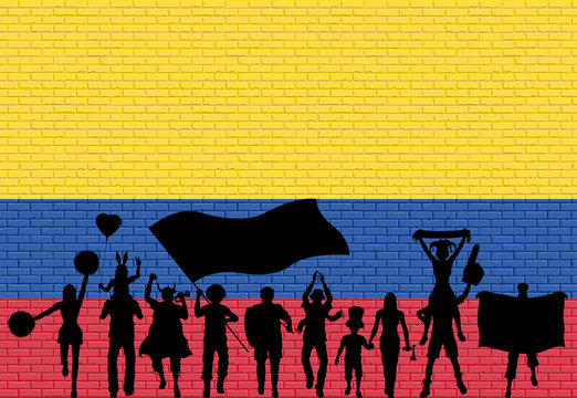 Colombian supporter silhouette in front of brick wall with Colombia flag