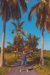 Man enjoying tropical climate with arms wide open.