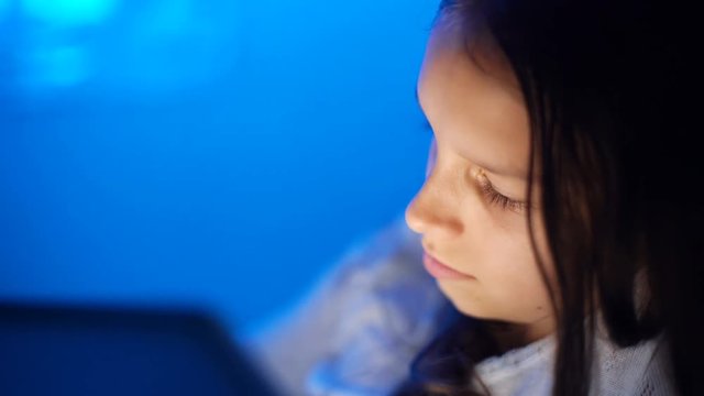 gadget night sleeplessness, caucasian girl chatting playing serfing network, bedtime playing with tablet in bed