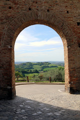 Gradara, Marche, Italy, May 2018. Countryside of central Italy view from an arch of the medieval walls of the village.