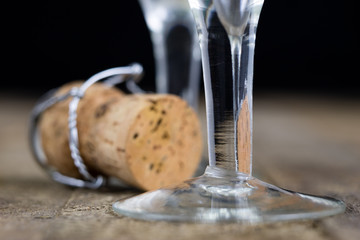 Cork from champagne on a wooden kitchen table. Good New Year's drinks and great fun.