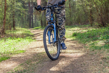 Fototapeta na wymiar A man on a bike riding on a forest trail