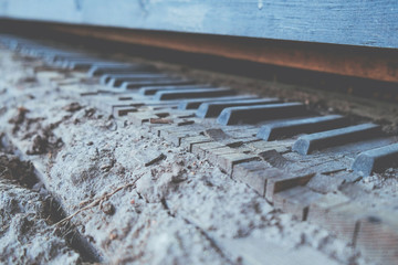 Old vintage broken piano keyboard background toned