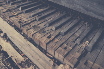 Old vintage broken piano keyboard background toned