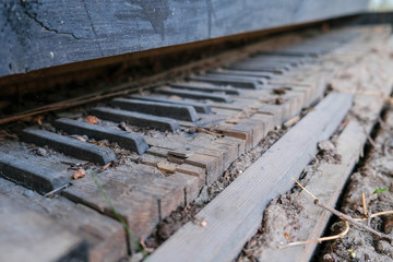 Old vintage broken piano keyboard background toned