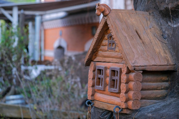Carved wooden toy brown house with windows outdoors