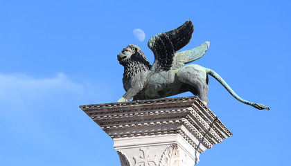 winged lion symbol of Venice above a column anf the moon on the