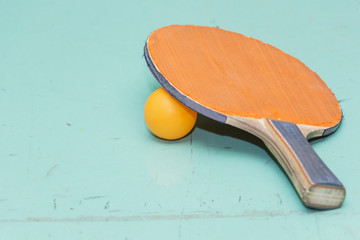 Old table tennis rackets on the game table.