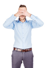 portrait young businessman covering his eyes with his hand. emotions, facial expressions, feelings, body language, signs. image on a white studio background.