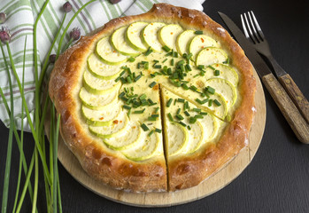 Homemade rustic pie with zucchini and green onions.