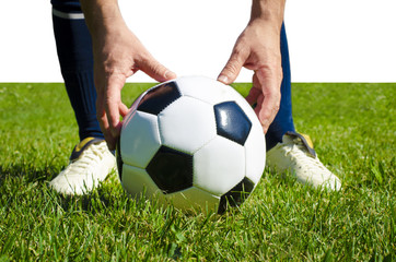 Close up legs of football player in blue socks and white shoes holding the ball in his hands placing it at the free kick or penalty spot playing on grass pitch isolated on white background
