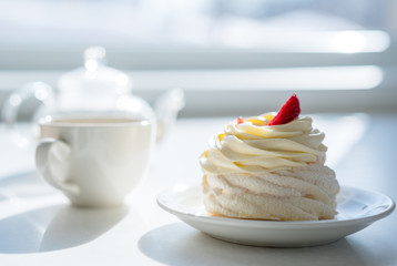 homemade cream cake on table in sunny room