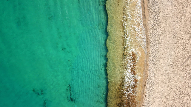 Aerial drone, bird's eye view photo of iconic and famous beach of Super Paradise with sapphire clear waters, Mykonos island, Cyclades, Greece © aerial-drone