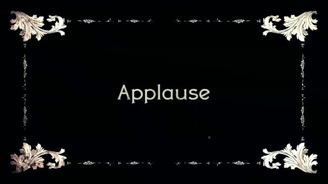 A re-created film frame from the silent movies era, showing an intertitle text: applause.
