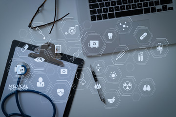 blank stethoscope and gray clipboard and eyeglasses and laptop computer on white desk background