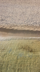 Aerial drone, bird's eye view photo of iconic and famous beach of Super Paradise with sapphire clear waters, Mykonos island, Cyclades, Greece