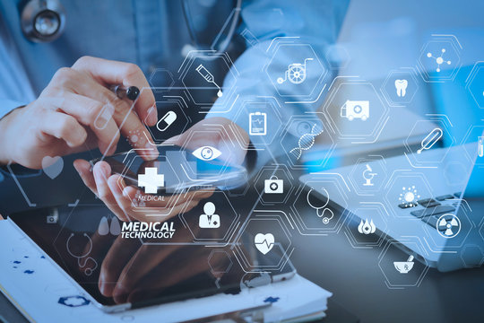 smart medical doctor working with smart phone and stethoscope and laptop and digital tablet computer on dark wooden desk