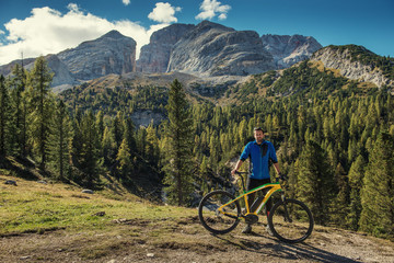 man with bike in italien dolomites, platzwiese, travel and adventure photography - obrazy, fototapety, plakaty