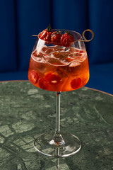 Tomato sprits cocktail on bar counter table. Refreshing Twist classic cocktail with Tomatoes, Aperol, Proseco and soda top, close-up