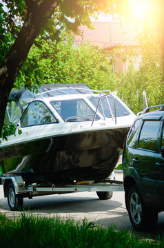 Motor Boat On A Trailer With A Car. The Concept Of Summer Holidays.