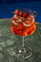 Tomato sprits cocktail on bar counter table. Refreshing Twist classic cocktail with Tomatoes, Aperol, Proseco and soda top, close-up