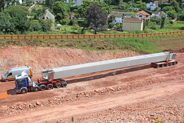 Truck transporting a concrete bridge beam