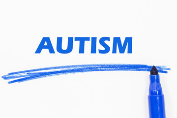AUTISM word written with blue marker