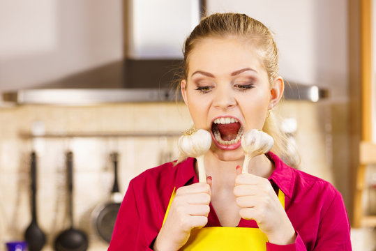 Crazy girl eating garlic vegetable