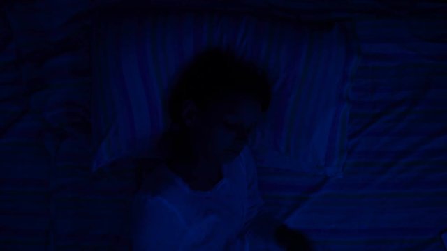 digital modern device addiction. gadget night sleeplessness. young caucasian girl browsing chatting playing serfing network with tablet bed. mobile phone apps.