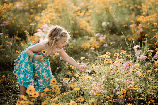 Girl in meadow full of flowers