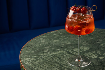 Tomato sprits cocktail on bar counter table. Refreshing Twist classic cocktail with Tomatoes, Aperol, Proseco and soda top, close-up