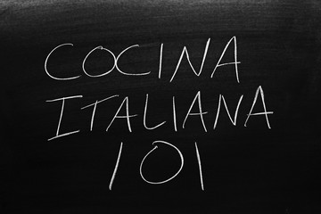 The words Cocina Italiana 101 on a blackboard in chalk.  Translation: Italian Cooking 101
