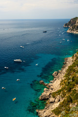 Capri Island, Italy - April 29 2018: Boats cruise in the turquoise Water of the beautiful Coastline of Capri