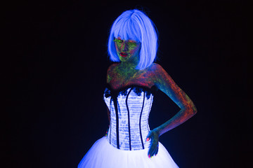 concept of fashion wedding photosession in neon lighting in vogue style bride glows in the dark...